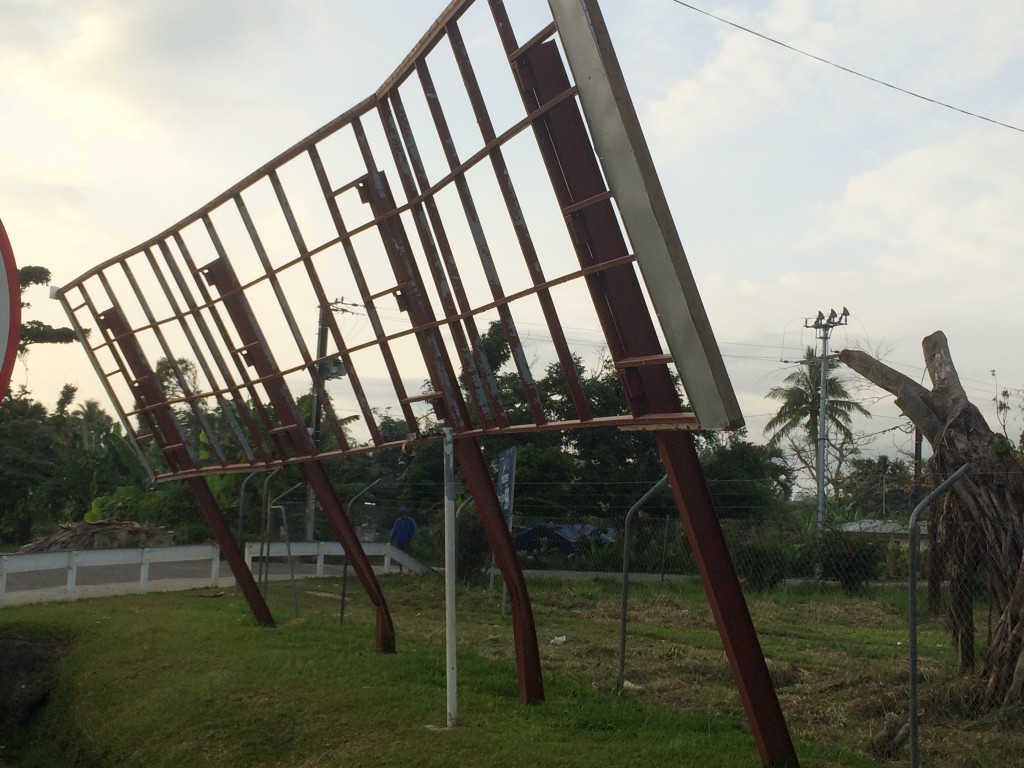 A sign buckles under the winds that passed with Cyclone Pam only 7 months ago.
